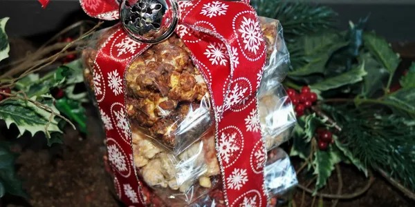 A gift bag filled with nuts and pretzels.