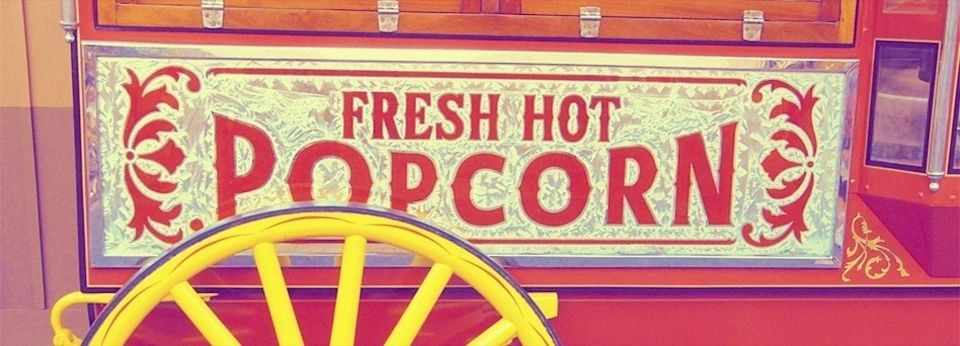 A sign that says fresh hot popcorn.