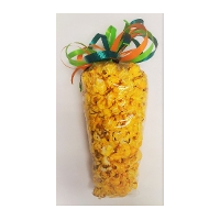 A corn on the cob with colorful ribbons around it.