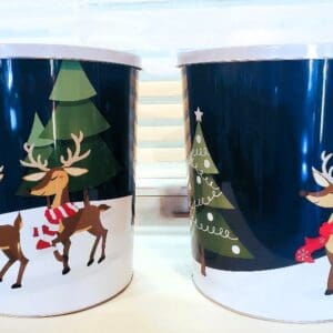 Two mugs with a picture of santa and his reindeer.